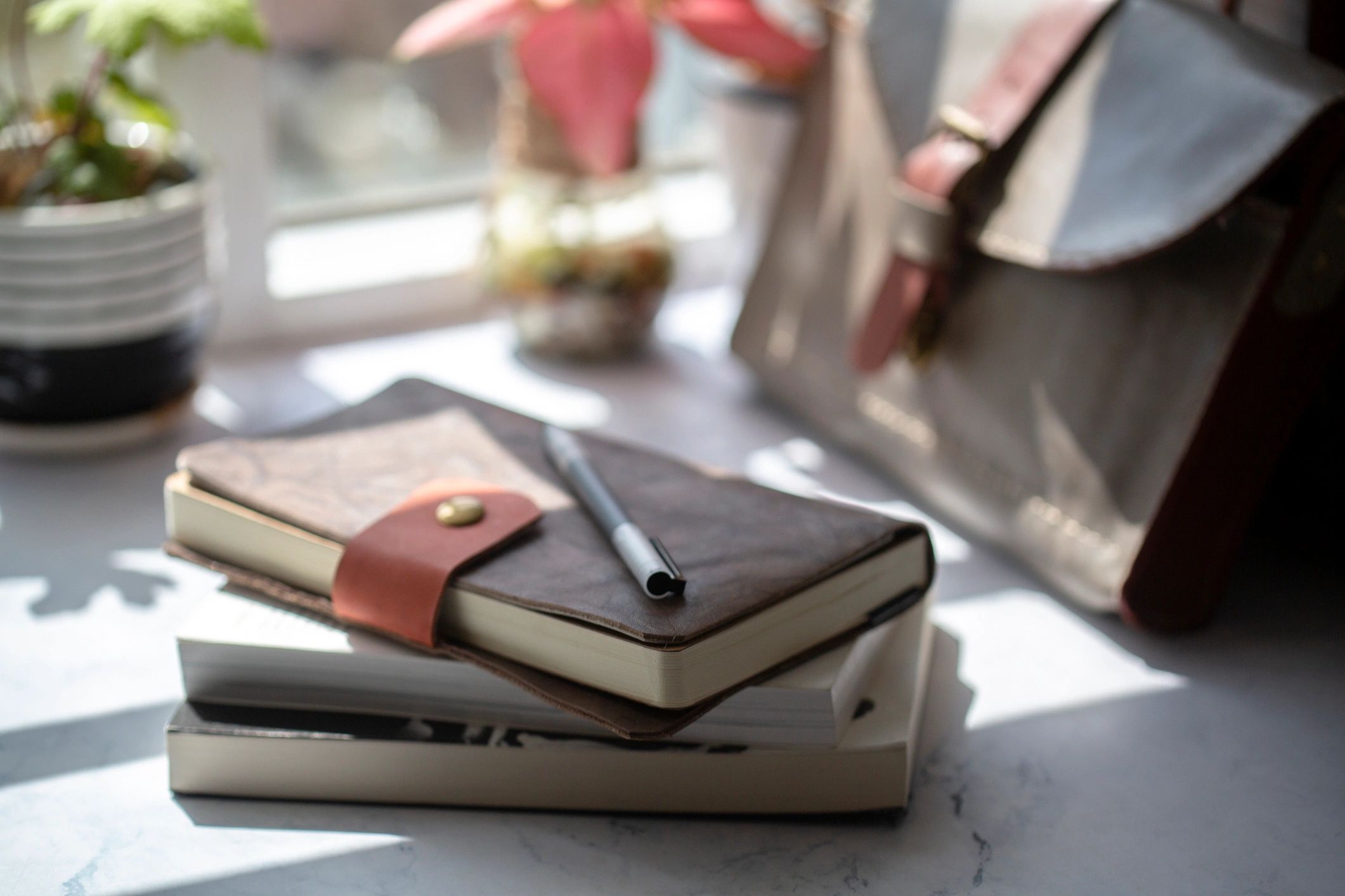 Notebook on a table by a window, representing planning and checklists