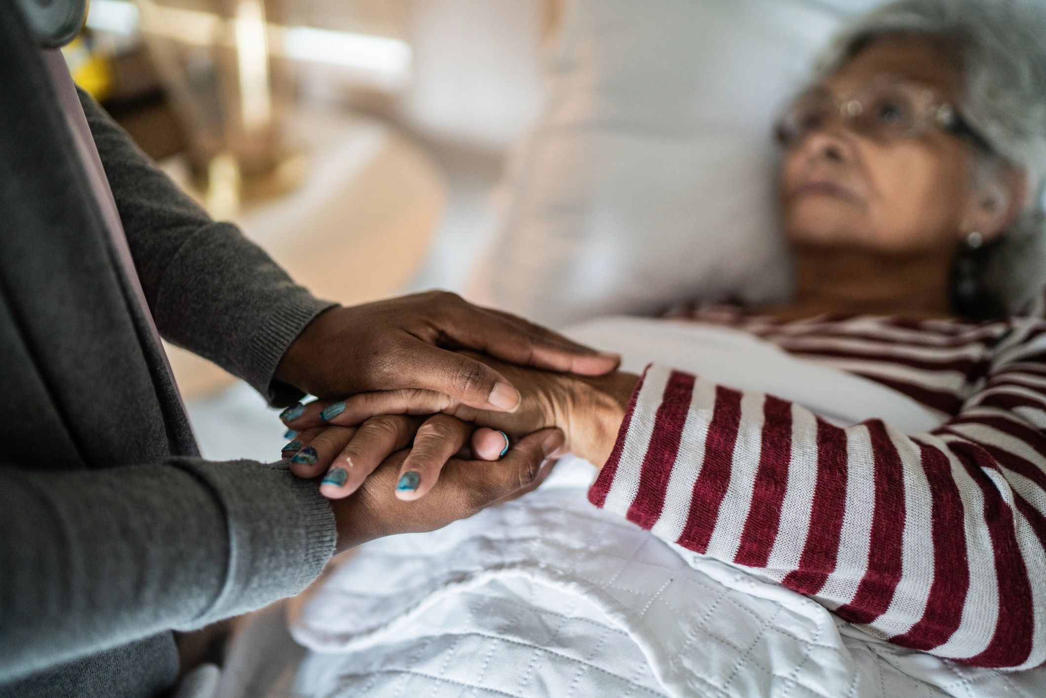 Caregiver talking to a senior woman in the bedroom