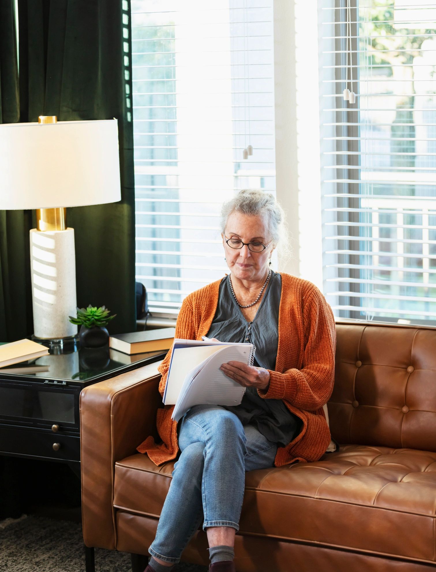 Person writing in a notebook at home