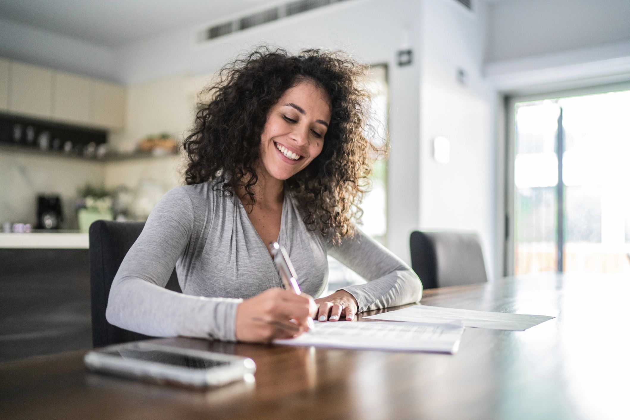 Author writing at a desk in warm light