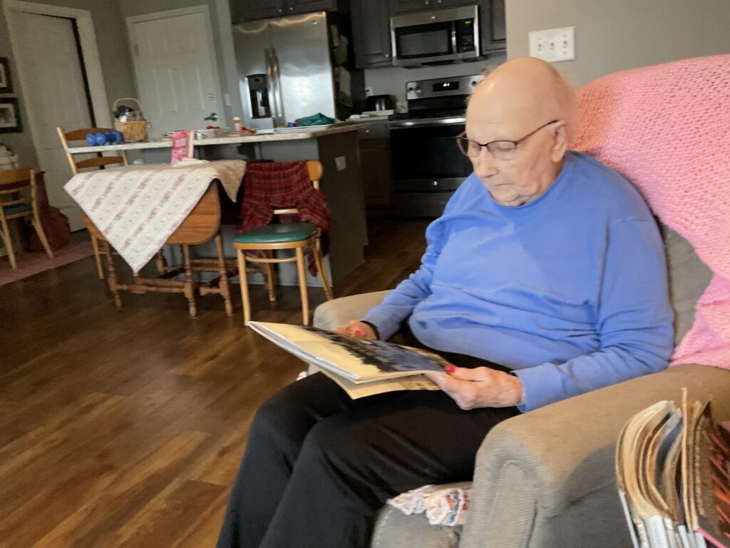 A caregiver can provide books with lots of photos that their loved one can relate too.  Marjory likes cats, and books about old farms.